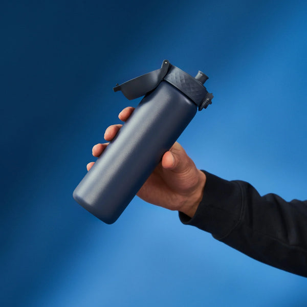 A dark gray water bottle stands upright with a flip-top lid and textured grip on a plain white background. Branding on the bottle reads ION8.