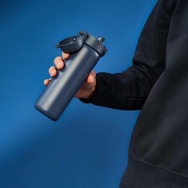 A dark gray water bottle stands upright with a flip-top lid and textured grip on a plain white background. Branding on the bottle reads ION8.