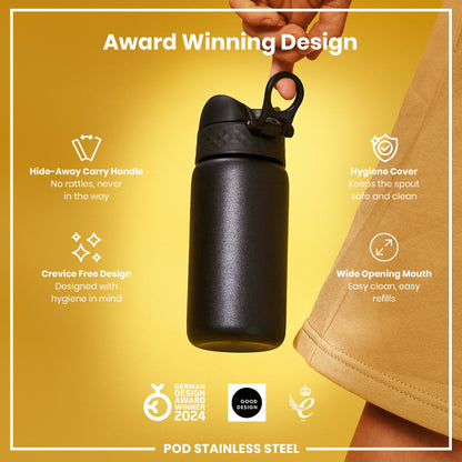 A black stainless steel water bottle is being held against a yellow background. Its features include a hide-away handle, hygiene cover, and wide mouth. The bottle is an award-winning design.