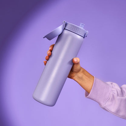 A lavender water bottle is held upright by a hand wearing a matching sleeve against a solid lavender background.