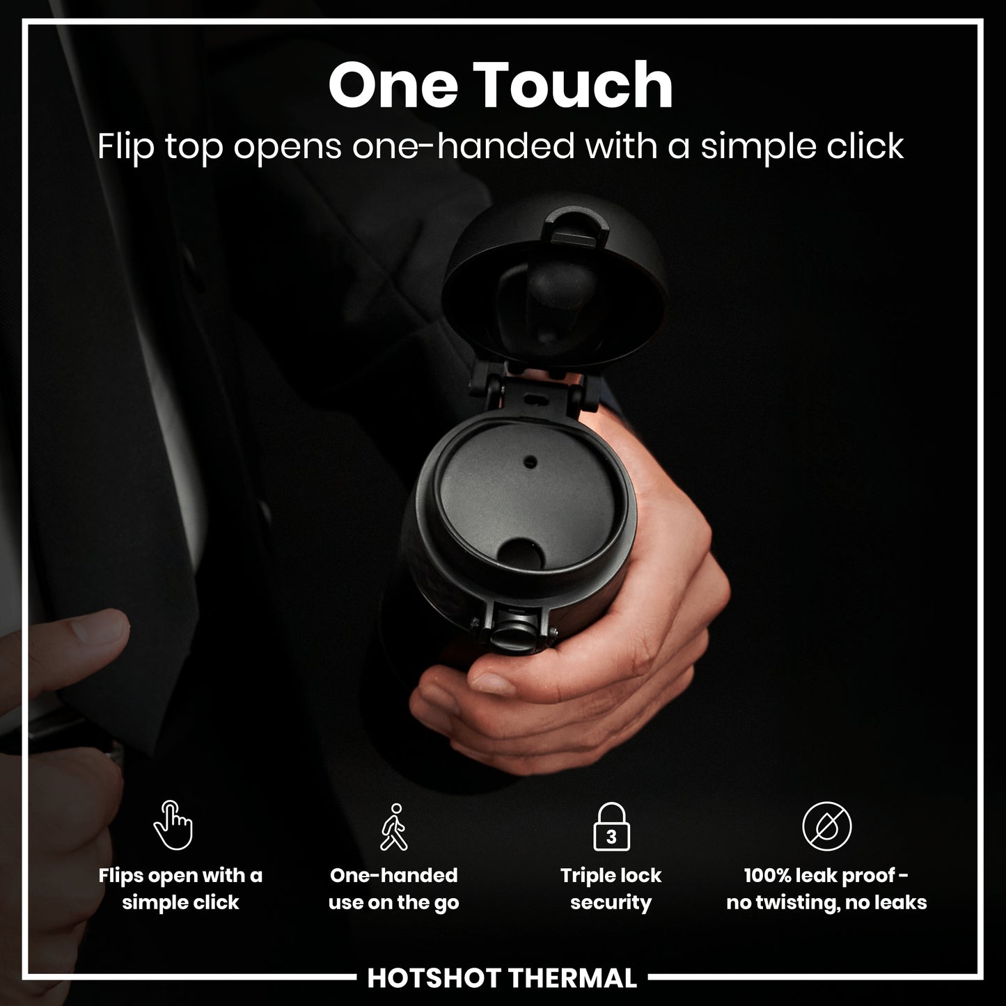 A black thermal flask's flip top is opened one-handed via a simple click by a person wearing a suit.