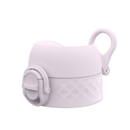 A pastel-colored bottle lid with a loop handle and a push-button spout rests on a flat surface featuring a textured diamond pattern design.