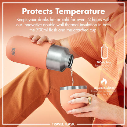 Person pours liquid from a peach-colored insulated flask into a matching cup against a peach background. Text reads: "Protects Temperature. Keeps your drinks hot or cold for over 12 hours with our innovative double wall thermal insulation in both the 700ml flask and the attached cup. 700ml/24oz flask fills over 2 full cups. Vacuum insulation. Innovative double wall thermal insulation." Branding: "TRAVEL FLASK."