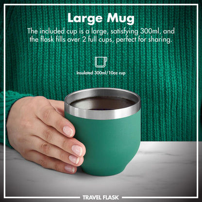 A hand holds a large green insulated mug filled with liquid against a textured green sweater background. Text reads: Large Mug The included cup is a large, satisfying 300ml, and the flask fills over 2 full cups, perfect for sharing. Insulated 300ml/10oz cup. Travel Flask.